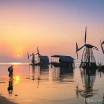 해양풍력 발전과 사회적 수용성 - **Prompt:** A poignant scene depicting a traditional Vietnamese fishing village at dawn. In the fore...